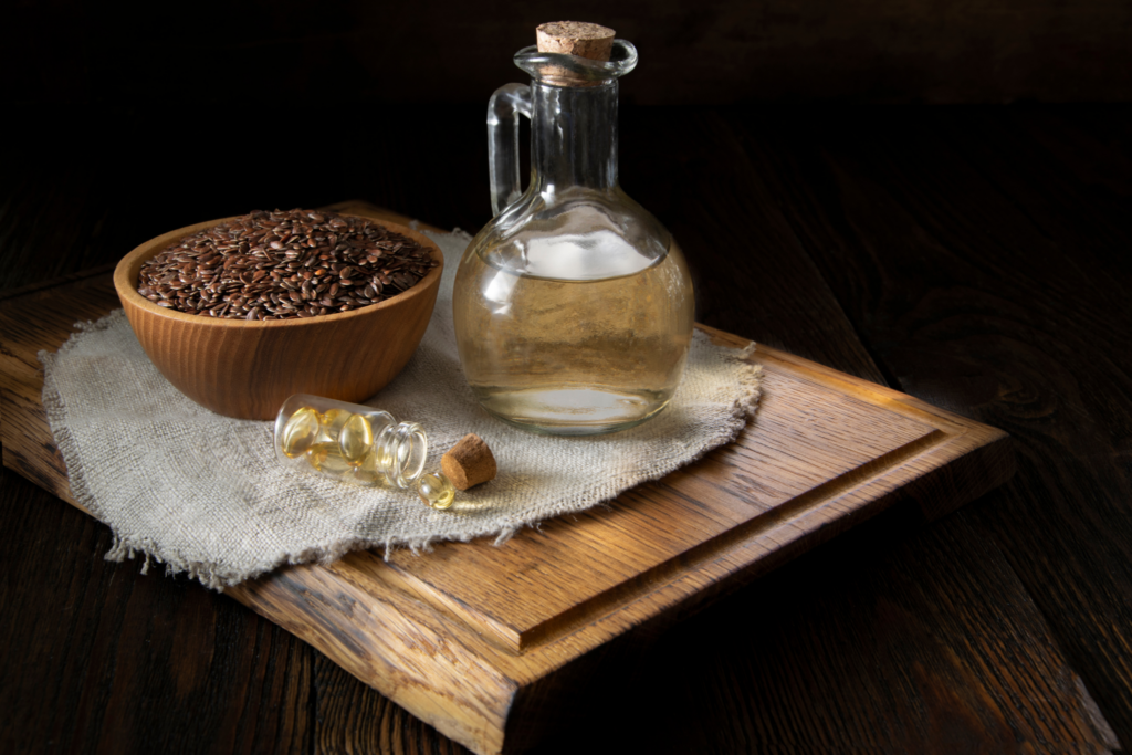 Lněná semínka, rostlinný olej a kapsle omega-3 podporující plodnost a zdravou pohyblivost spermií.